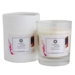 A tall, round candle with a rose-based scent. The candle is made of high-quality materials and has a long-lasting burn time.