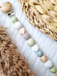 Pacifier clip with pastel-colored wooden beads, featuring a natural, earthy design.