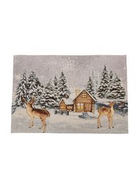  A winter scene with a snowy forest and a log cabin, with two deer standing in the foreground. The placemat appears to be made of a woven or tapestry-like material, with a Gobelin-style design.