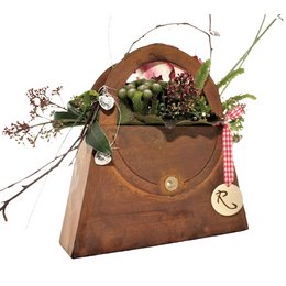 Decorative metal planter in a rustic, vintage-inspired design with a patina finish. Features a floral arrangement in a leather-like pouch. Available in 3 sizes.

The image shows a decorative metal planter with a rustic, vintage-inspired design and a patina finish. The planter is in the shape of a leather-like pouch or envelope, and it contains a floral arrangement inside. The product appears to be available in 3 different size variants.

Based on the details provided, the key product features that could be useful for a semantic search include:
- Material: Metal with a patina finish
- Style: Rustic, vintage-inspired
- Shape: Pouch or envelope-like
- Contents: Floral arrangement
- Sizes: 3 variants available