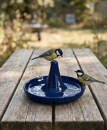  "Blue ceramic bird feeder, round shallow dish design with central pedestal, outdoor garden watering station"