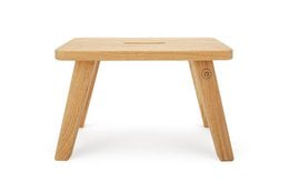 Robust oak wood stool "Emil" in warm honey finish. Sturdy and durable construction, suitable for use as a side table or footrest.