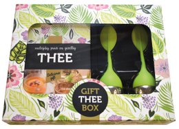  A gift box containing tea, featuring a tropical leaf pattern design. The box includes two tea cups or glasses.