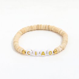 Beige bracelet with gold-tone beads spelling "Ciao" for kids.
