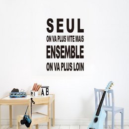 Wall sticker with French text "Seul on va plus vite, ensemble on va plus loin" meaning "Alone we go faster, together we go further". The sticker features a modern, minimalist design with black text and a decorative wooden element.