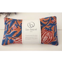  Terracotta eye cushion with intricate floral pattern in shades of orange, blue, and red. Made of soft, comfortable material.