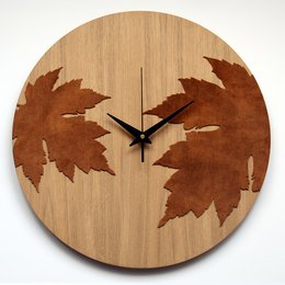 Wooden wall clock with autumn-themed maple leaf design. Features a round wooden frame with laser-cut maple leaves in warm brown tones, creating a rustic and natural aesthetic.