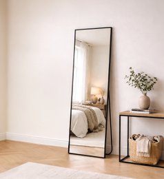 Black framed tall rectangular standing mirror, modern minimalist design, full-length floor mirror