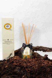  Earthy-toned reed diffuser with a natural, botanical scent. Features a glass bottle with wooden reeds, packaged in a minimalist, cream-colored box.