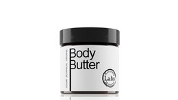 A white body butter jar with a black lid. The product is a moisturizing body butter.