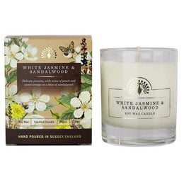 A tall, round white candle with a floral and butterfly design on the packaging. The candle is scented with white jasmine and sandalwood.