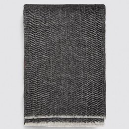 A long, gray herringbone-patterned scarf with fringed edges.