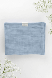 Soft, lightweight baby blue muslin blanket made of high-quality cotton.