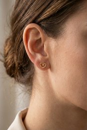  Stainless steel stud earrings in a heart shape design by Lundholm, a Scandinavian jewelry brand. Available in gold and silver color variants.