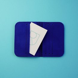 Compact, minimalist leather card sleeve in a deep blue color.