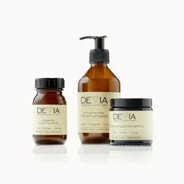 A set of hair removal products from the DEVIA brand, including a starter kit. The products feature amber-colored bottles and jars with a minimalist, natural-inspired design.