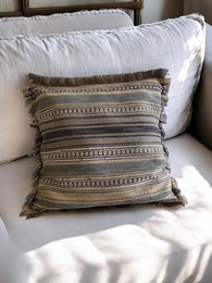 Wabi cushion cover in neutral tones with geometric patterns, suitable for a couch or chair.