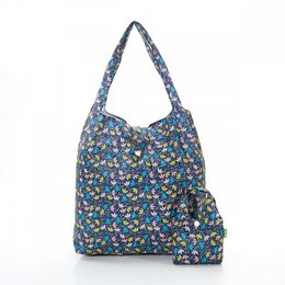 Dark blue shopper bag with a floral print pattern made from recycled nylon material.