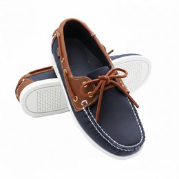  Navy leather boat shoes with laces, brown accents, white sole, classic nautical loafers for men.