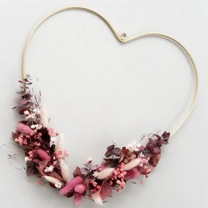 Declaration of love in flowers: Golden heart with dried flowers in pink and red