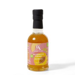 Organic balsamic cream with peach flavor, packaged in a 200 ml glass bottle or 500 ml plastic bottle. The product is made from high-quality ingredients and has a sweet and tangy taste.
