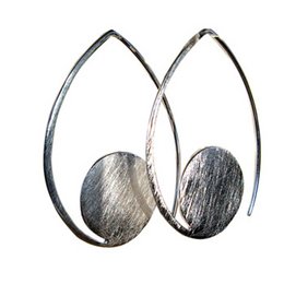 Silver teardrop-shaped earrings with a brushed metal finish, suitable for statement jewelry.