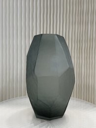 Large, smoky gray, geometric vase with an angular, faceted design.