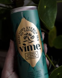 Natural energy tea in a green can with the brand name "Vime" prominently displayed.