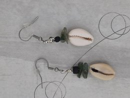 Cowrie shell earrings with moss agate crystals, featuring a natural shell pendant and green crystal accents.