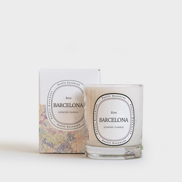 Tall round rose-scented candle in Barcelona Collection packaging.