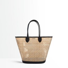 Black leather shoulder bag with woven straw body and black leather handles.