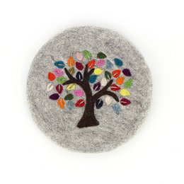 A round, gray felt trivet with an embroidered tree of life design featuring colorful leaves.