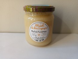 Creamy burgundy spring honey, 250gr jar, golden beige color, floral label, glass container with metal lid.