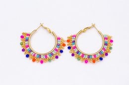 Stainless steel gold-tone earrings with a statement design featuring a vibrant array of colorful gemstones in various shapes and sizes, creating a bold and eye-catching accessory.