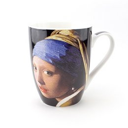 Ceramic mug featuring the iconic painting "Girl with a Pearl Earring" by Johannes Vermeer. The mug has a black background with the woman's face and pearl earring prominently displayed.
