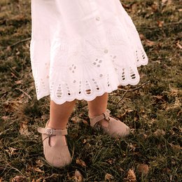 Taupe baby shoes with delicate lace detailing, suitable for sizes 18-21.