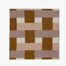 Multicolored cotton knitted dish cloth with a patchwork pattern of rectangular shapes in shades of pink, brown, and white.