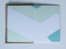 Greeting card with abstract geometric pattern in pastel colors of mint green, light blue, and white. The design features a simple chevron or triangular pattern.
