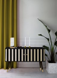 Black and white striped chest of drawers with gold accents, suitable for a modern or minimalist home decor.