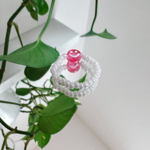 Pearl ring made of white glass beads with a pink smiley