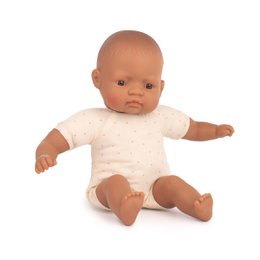 A 32cm baby doll with a Latin girl appearance, wearing a white outfit.