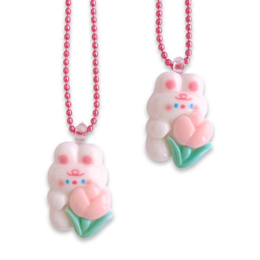 "Pop Cutie Tulip Bunny Kids Necklace - A whimsical and adorable necklace featuring a white bunny holding a pink tulip flower. Perfect for kids' fashion and accessory needs."

The image shows two identical necklace pendants featuring a white bunny character holding a pink tulip flower. The pendants have a cute and playful design, suitable for children's fashion and accessories. The necklaces have pink beaded chains.