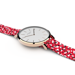 Rose gold and silver-tone watch with a red and white polka dot strap.
