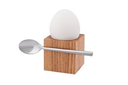 Wooden cube egg stand with stainless steel spoon for serving soft boiled eggs.
