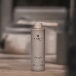  A white cylindrical bottle labeled "Vision" containing a body lotion refill product. The bottle has a simple, minimalist design with the brand name prominently displayed.