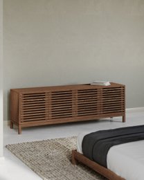  Ash wood media console with four doors and horizontal slat design in a roux finish.