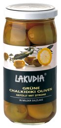 Green Halkidiki olives stuffed with lemon. Olives in glass jar. Olive product with citrus flavor.