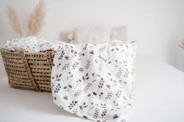  Soft, organic muslin baby blanket with delicate dried flower pattern, perfect for snuggling and soothing your little one.