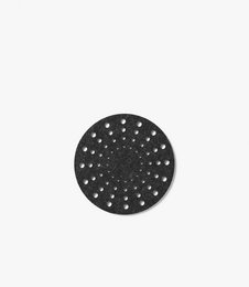 Round black tea coaster with perforated design.