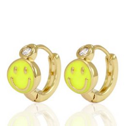  Bright yellow smiley face earrings with clear rhinestone accents, designed for children's wear.